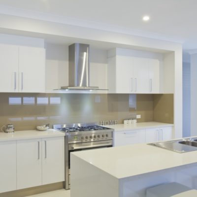 white kitchen with glass splashback