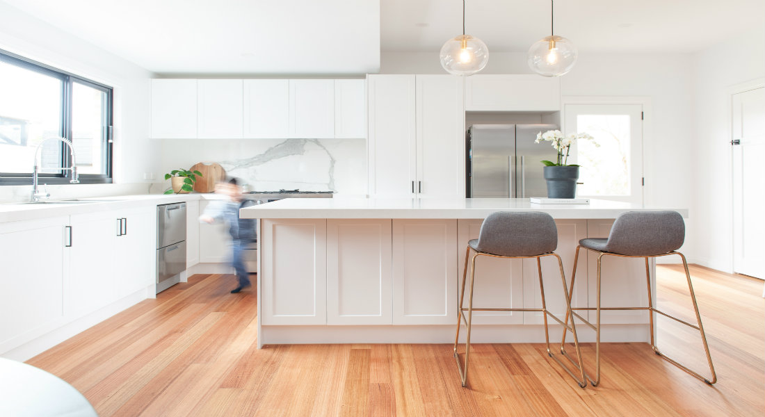 White kitchen with timber floor and benchtop