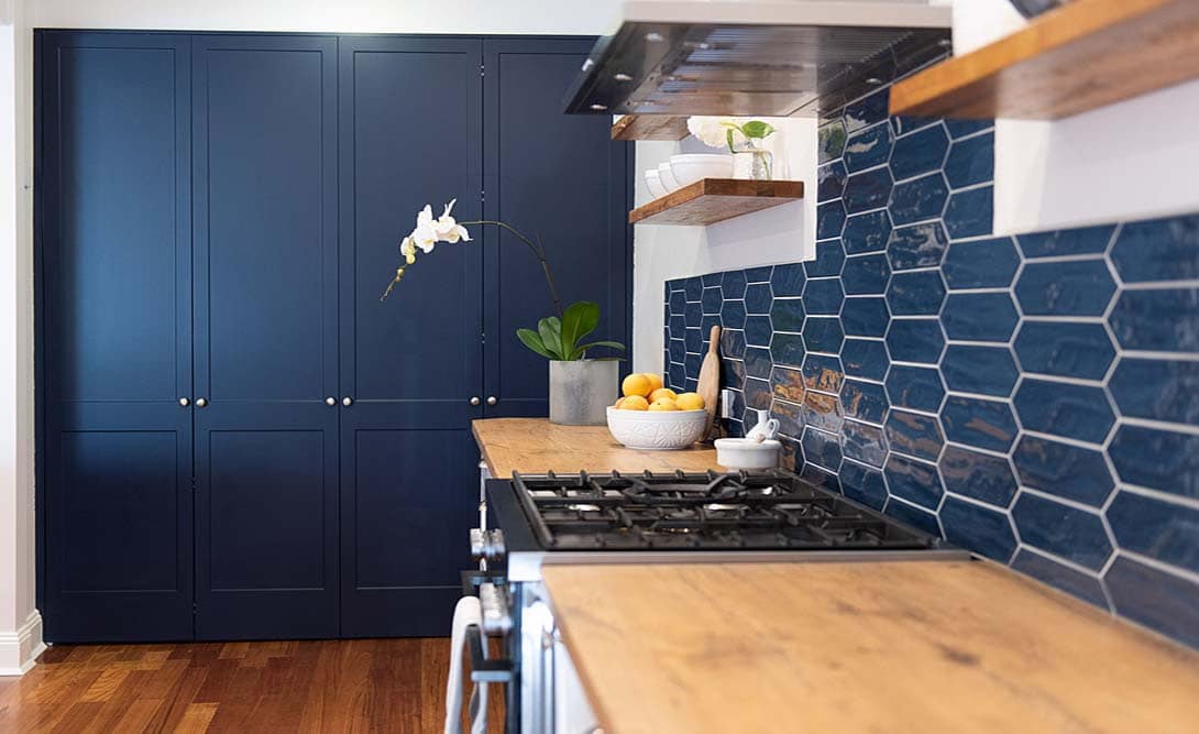Navy kitchen cabinetry and timber benchtops