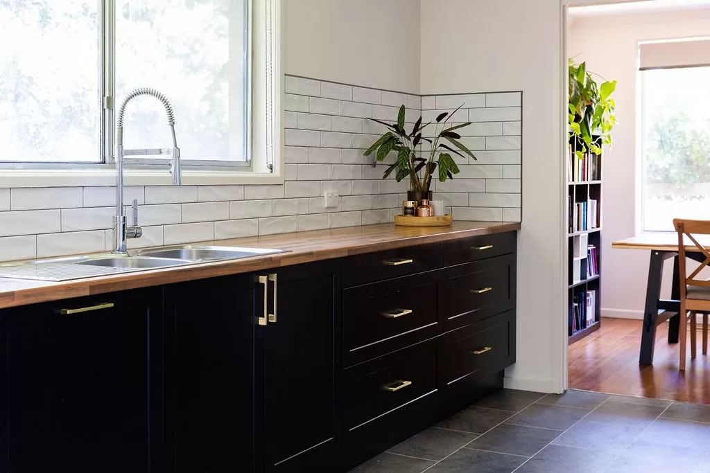 Black kitchen cabinetry with timber benchtops